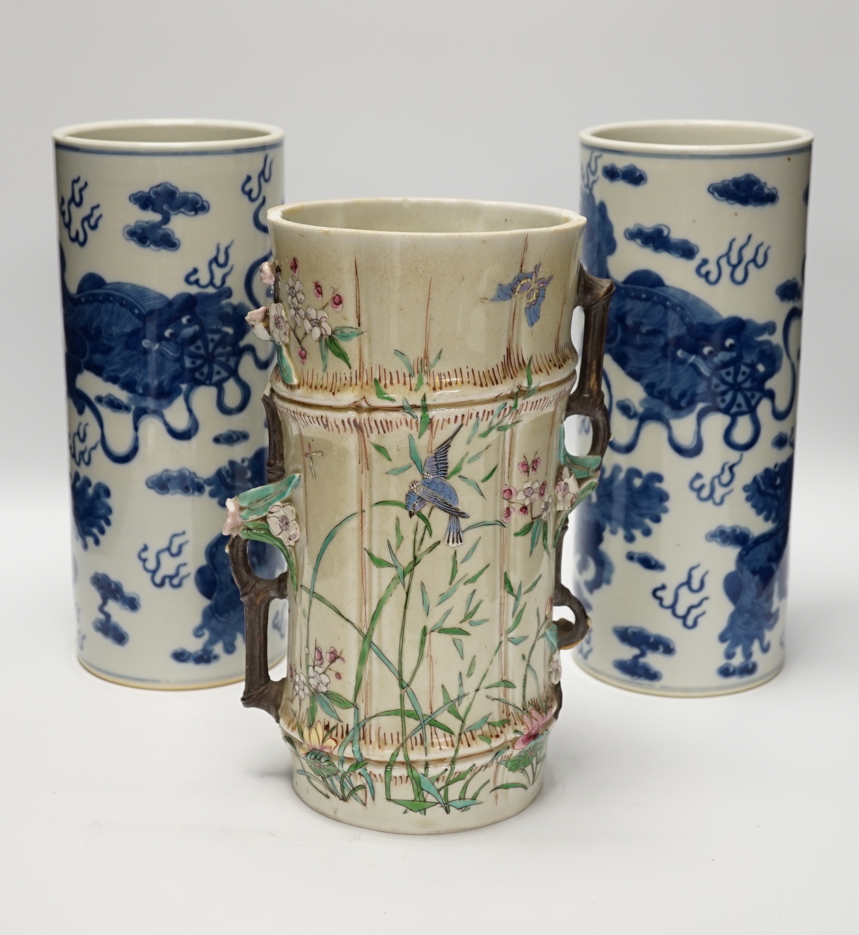 A pair of Chinese blue and white cylindrical hat stands, 29cm high and a Japanese porcelain vase modelled as bamboo